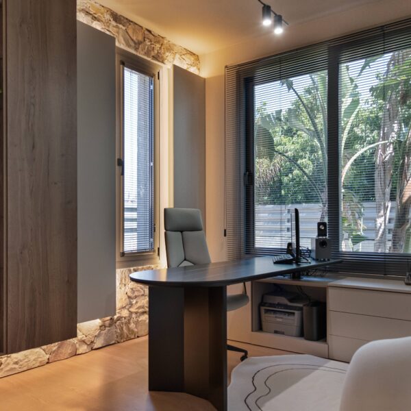 Luxury home office design in Nicosia with modern minimalist style by Migliore Interiors Custom built-in cabinetry and shelving in a contemporary Cyprus office interior Elegant office desk and ergonomic seating in Migliore Nicosia No. 14 project Warm ambient lighting and hidden cove lights in a luxury Nicosia office space Refined material palette with wood tones and matte finishes in a modern home office Minimalist office layout with natural light and bespoke storage solutions in Nicosia Luxury Cyprus interior design featuring functional workspace and elegant details Contemporary home office retreat with calm, refined atmosphere by Migliore Interiors