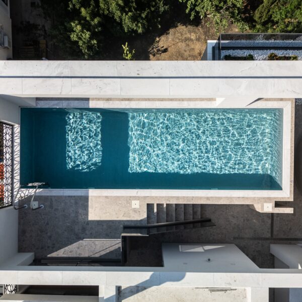 “After – Rooftop garden with natural stone paving and seating area” “After – Timber pergola shading outdoor lounge on roof terrace” “After – Built-in planter beds with greenery in rooftop design” “After – Evening rooftop garden with ambient outdoor lighting” “After – Detail of stone paving and glass railing overlooking Nicosia
