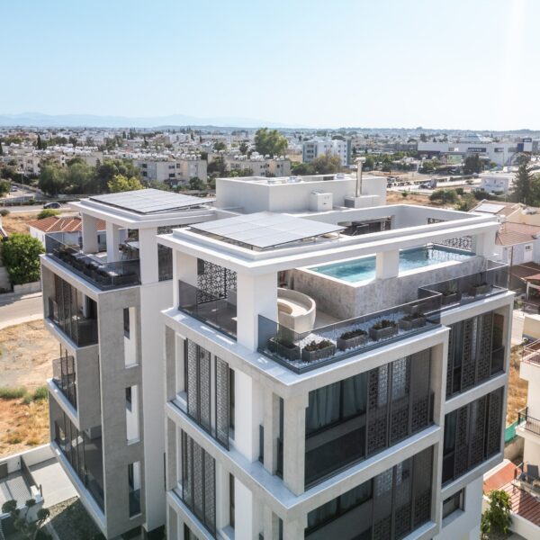 “After – Rooftop garden with natural stone paving and seating area” “After – Timber pergola shading outdoor lounge on roof terrace” “After – Built-in planter beds with greenery in rooftop design” “After – Evening rooftop garden with ambient outdoor lighting” “After – Detail of stone paving and glass railing overlooking Nicosia