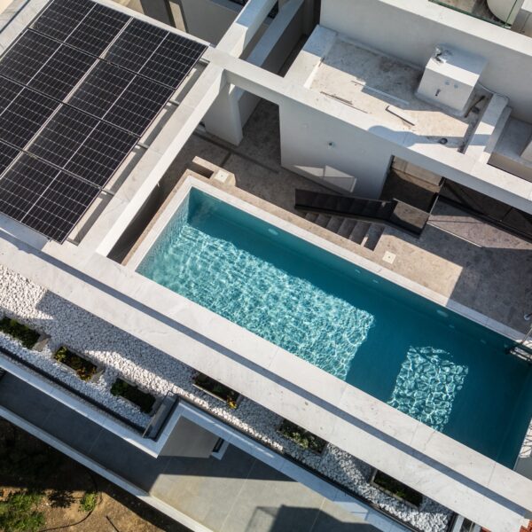 “After – Rooftop garden with natural stone paving and seating area” “After – Timber pergola shading outdoor lounge on roof terrace” “After – Built-in planter beds with greenery in rooftop design” “After – Evening rooftop garden with ambient outdoor lighting” “After – Detail of stone paving and glass railing overlooking Nicosia