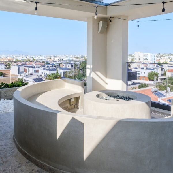 “After – Rooftop garden with natural stone paving and seating area” “After – Timber pergola shading outdoor lounge on roof terrace” “After – Built-in planter beds with greenery in rooftop design” “After – Evening rooftop garden with ambient outdoor lighting” “After – Detail of stone paving and glass railing overlooking Nicosia