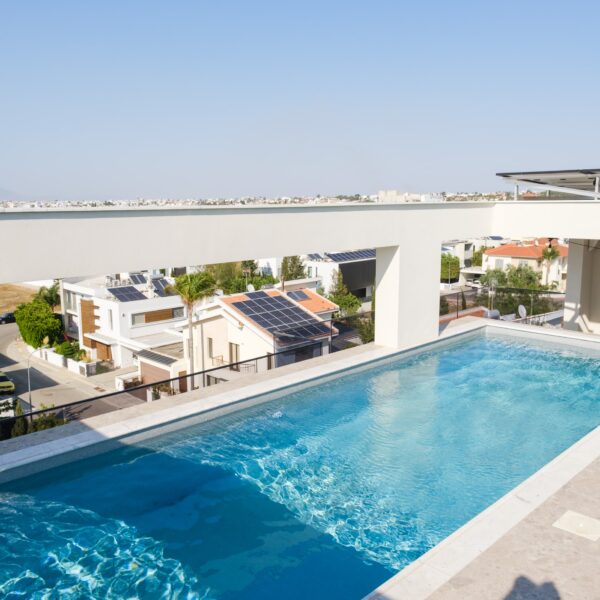 “After – Rooftop garden with natural stone paving and seating area” “After – Timber pergola shading outdoor lounge on roof terrace” “After – Built-in planter beds with greenery in rooftop design” “After – Evening rooftop garden with ambient outdoor lighting” “After – Detail of stone paving and glass railing overlooking Nicosia