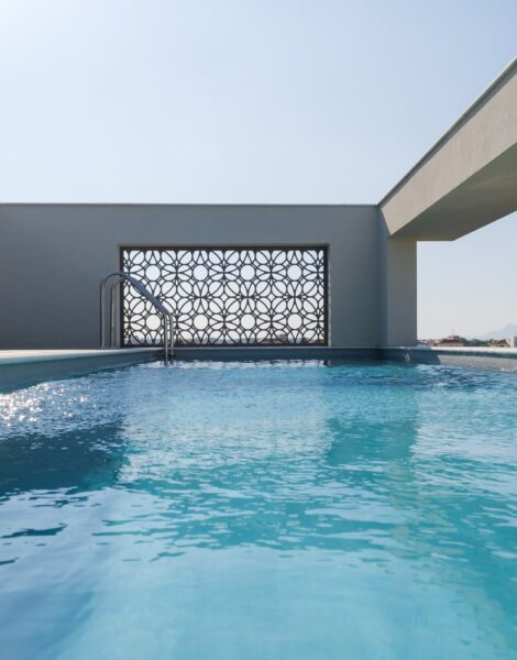 “After – Rooftop garden with natural stone paving and seating area” “After – Timber pergola shading outdoor lounge on roof terrace” “After – Built-in planter beds with greenery in rooftop design” “After – Evening rooftop garden with ambient outdoor lighting” “After – Detail of stone paving and glass railing overlooking Nicosia