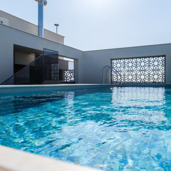 “After – Rooftop garden with natural stone paving and seating area” “After – Timber pergola shading outdoor lounge on roof terrace” “After – Built-in planter beds with greenery in rooftop design” “After – Evening rooftop garden with ambient outdoor lighting” “After – Detail of stone paving and glass railing overlooking Nicosia