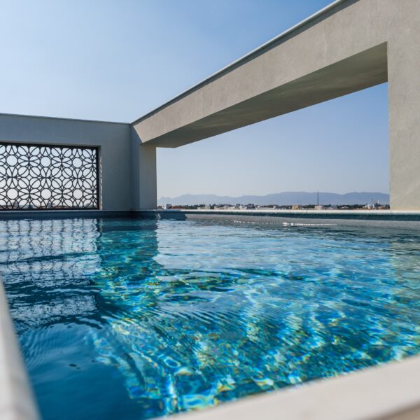 “After – Rooftop garden with natural stone paving and seating area” “After – Timber pergola shading outdoor lounge on roof terrace” “After – Built-in planter beds with greenery in rooftop design” “After – Evening rooftop garden with ambient outdoor lighting” “After – Detail of stone paving and glass railing overlooking Nicosia