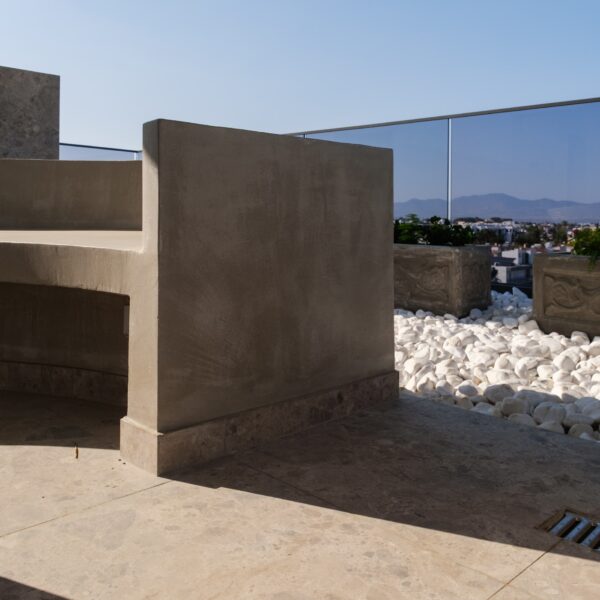 “After – Rooftop garden with natural stone paving and seating area” “After – Timber pergola shading outdoor lounge on roof terrace” “After – Built-in planter beds with greenery in rooftop design” “After – Evening rooftop garden with ambient outdoor lighting” “After – Detail of stone paving and glass railing overlooking Nicosia