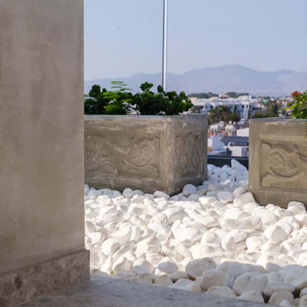 “After – Rooftop garden with natural stone paving and seating area” “After – Timber pergola shading outdoor lounge on roof terrace” “After – Built-in planter beds with greenery in rooftop design” “After – Evening rooftop garden with ambient outdoor lighting” “After – Detail of stone paving and glass railing overlooking Nicosia